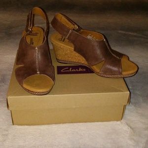 Women's brown suede open toe wedges.